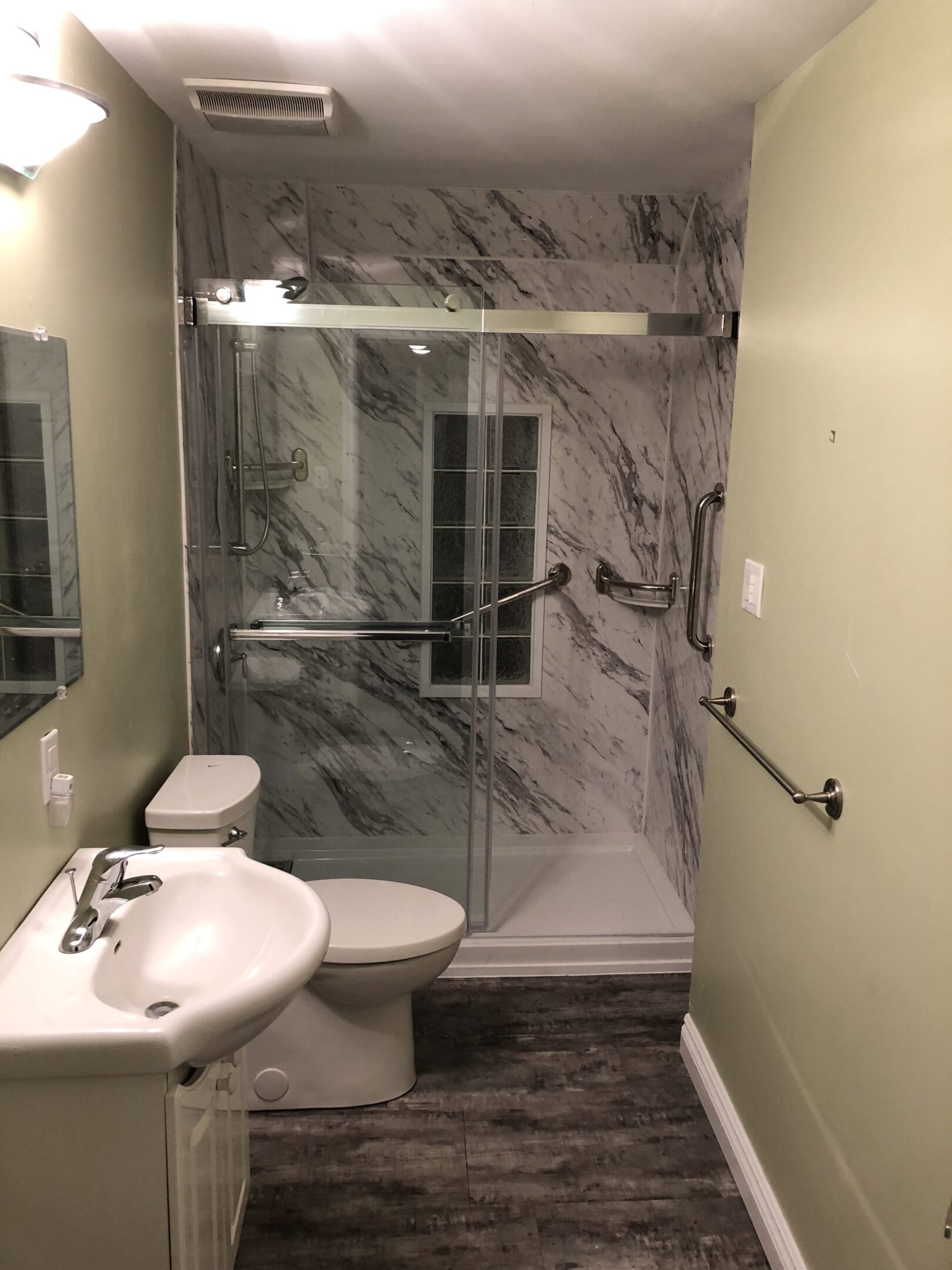 Bathroom featuring marble walls and fixtures
