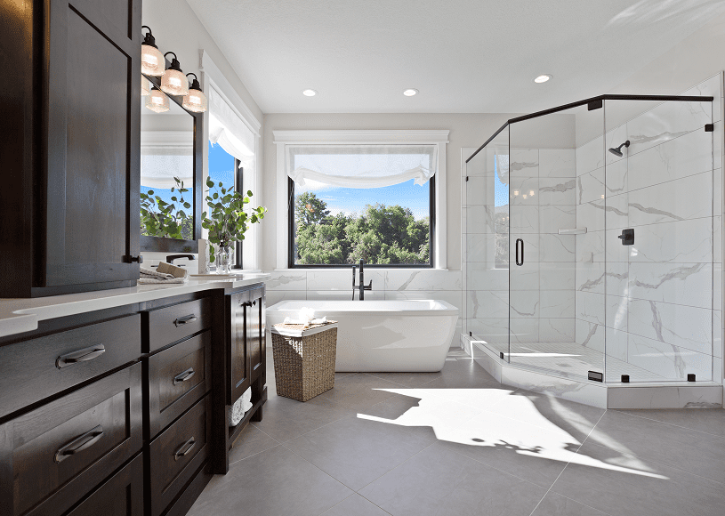 Bright modern bathroom with large windows and a freestanding tub.