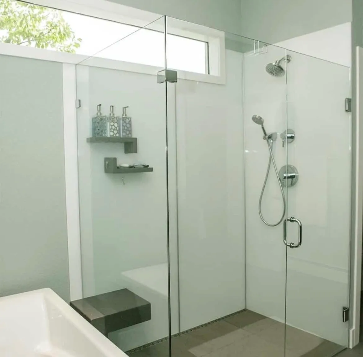 Modern bathroom with glass shower enclosure and sleek fixtures.
