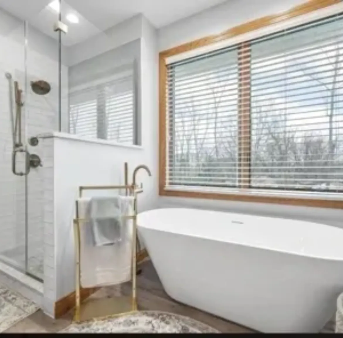 Modern bathroom with a freestanding tub and glass shower.