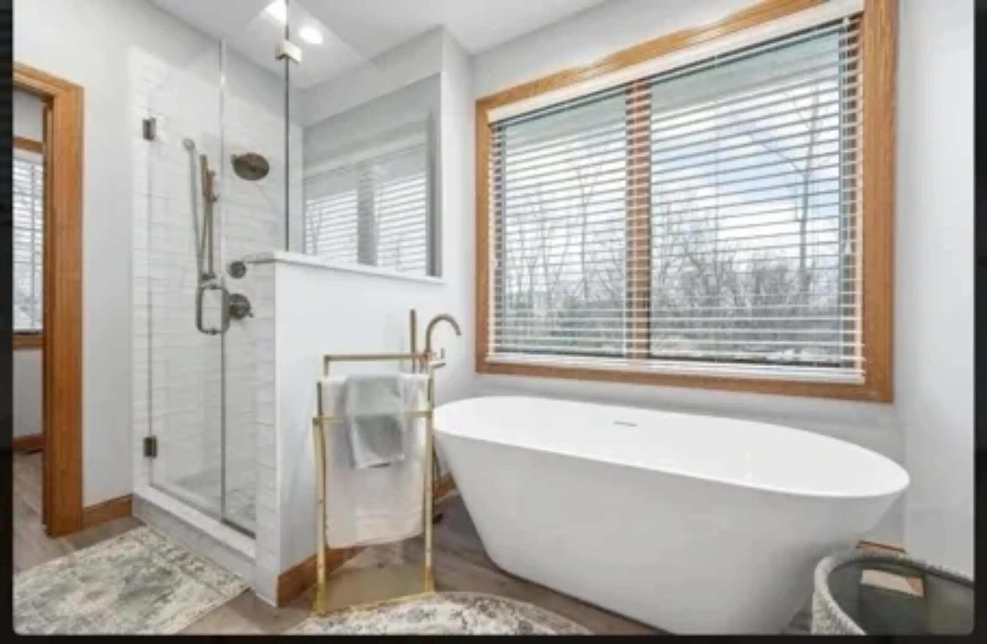 Modern bathroom with freestanding tub and glass shower.
